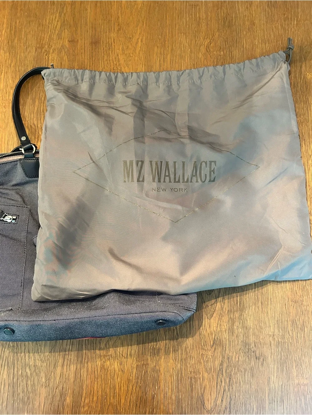MZ Wallace navy canvas tote with leather pocket and handles